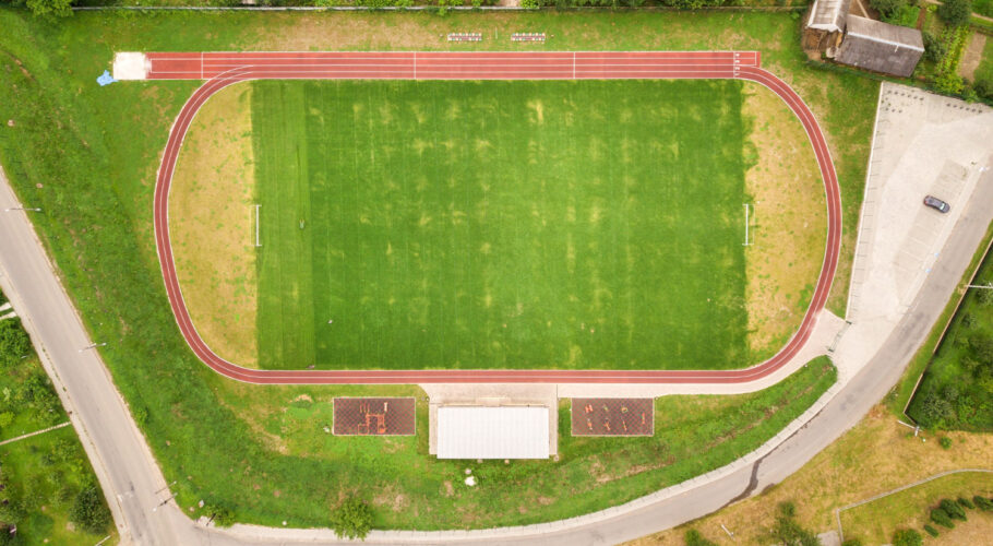 aerial view of school sports oval with running tracks and football field