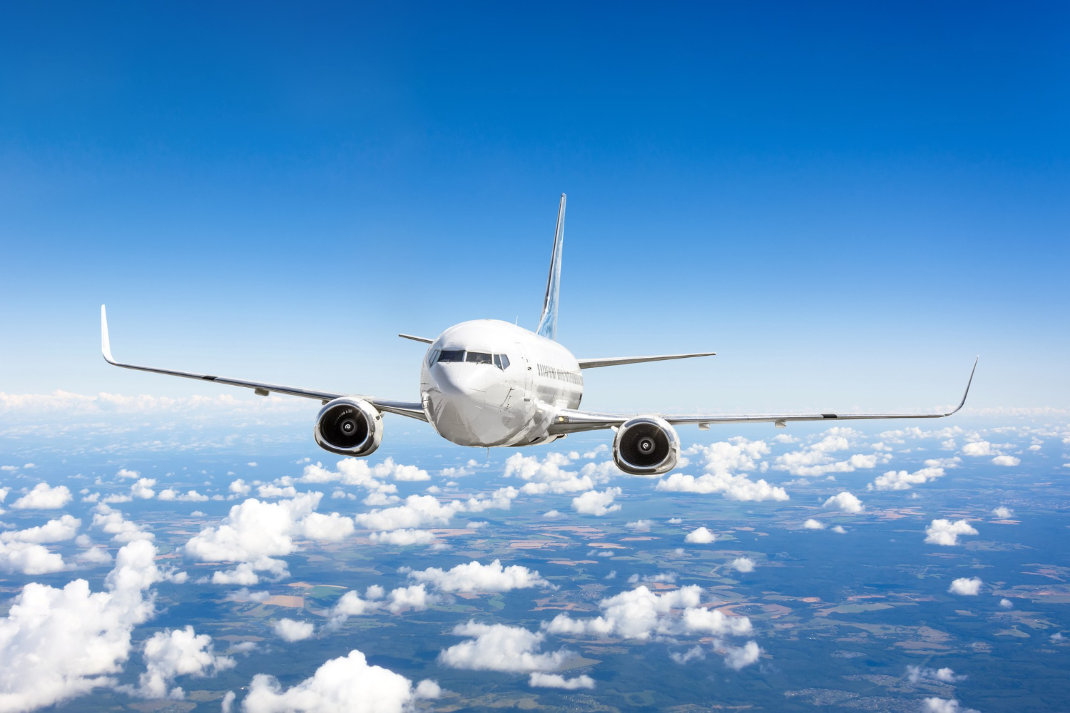 airplane flies summer clouds earth surface blue sky
