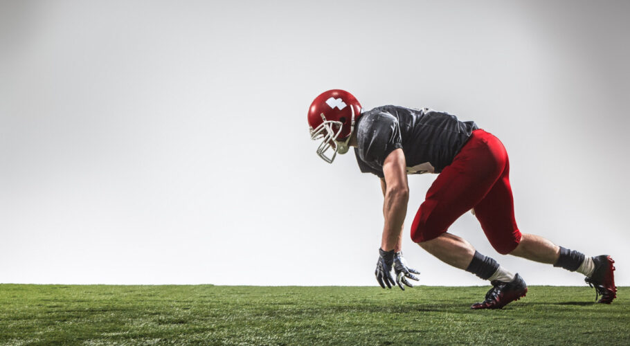 american football gridiron player on green grass practice session