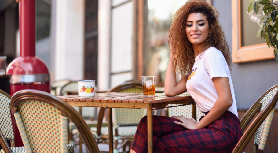 arab girl casual clothes drinking soda outdoors bar penelope