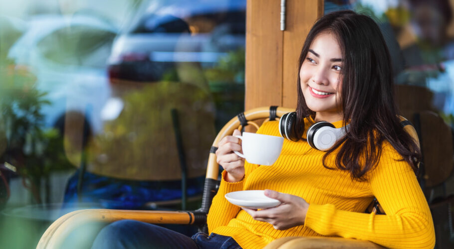 asian young female holding cup coffee sitting modern coffee shop coworking space china starbucks