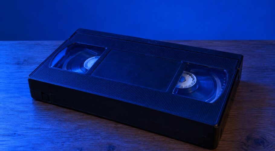 A black VHS video cassette on a wooden table