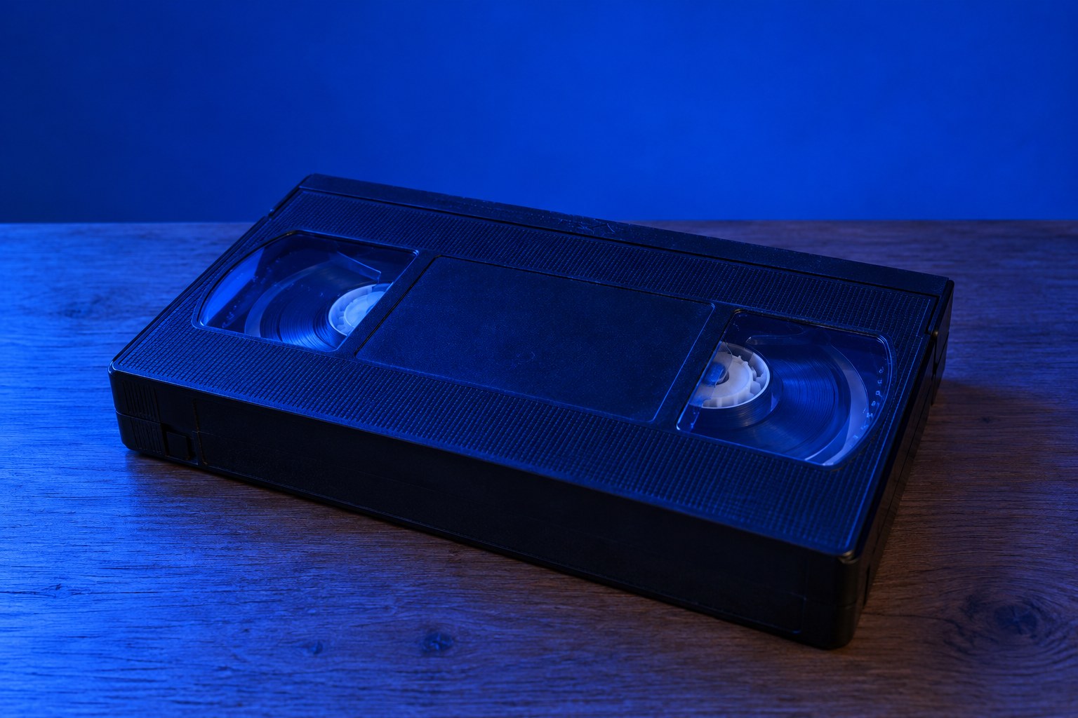 A black VHS video cassette on a wooden table