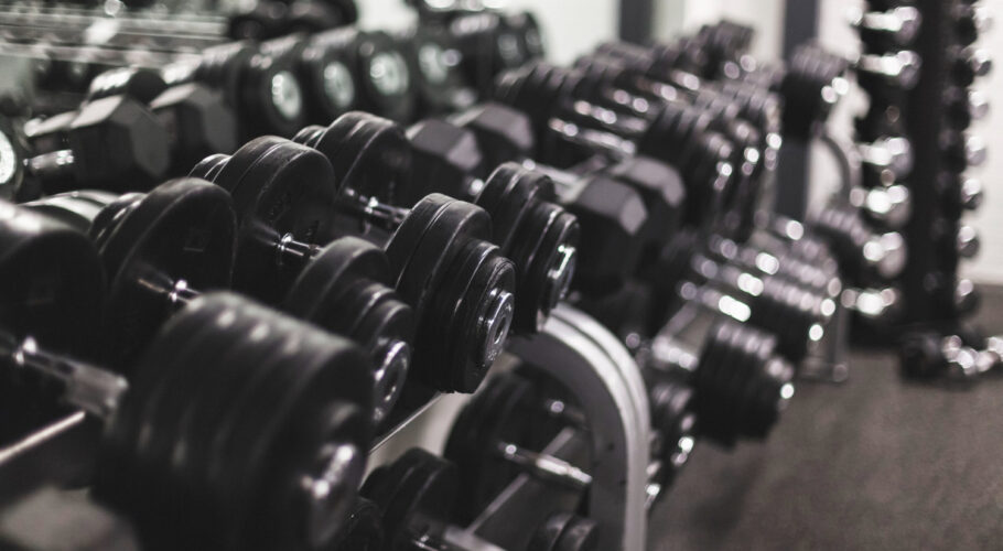 close up of dumbbells arranged in a row in bodybuilding fitness gym