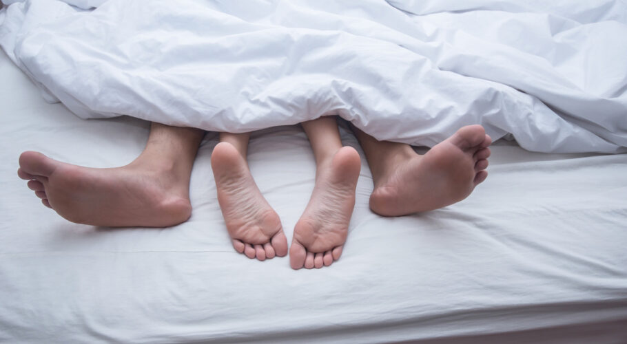 close up legs couple bed