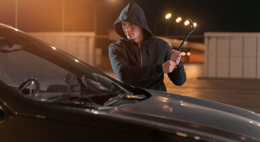 close up man trying break into car