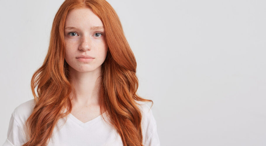 closeup serious beautiful redhead young woman kathryn with long wavy hair freckles wears shirt