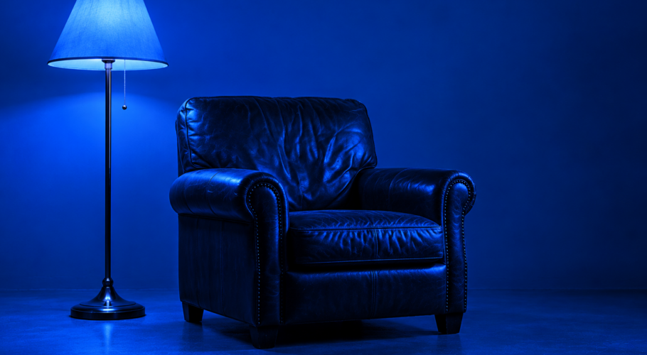 Leather armchair beside a standing lamp in blue light