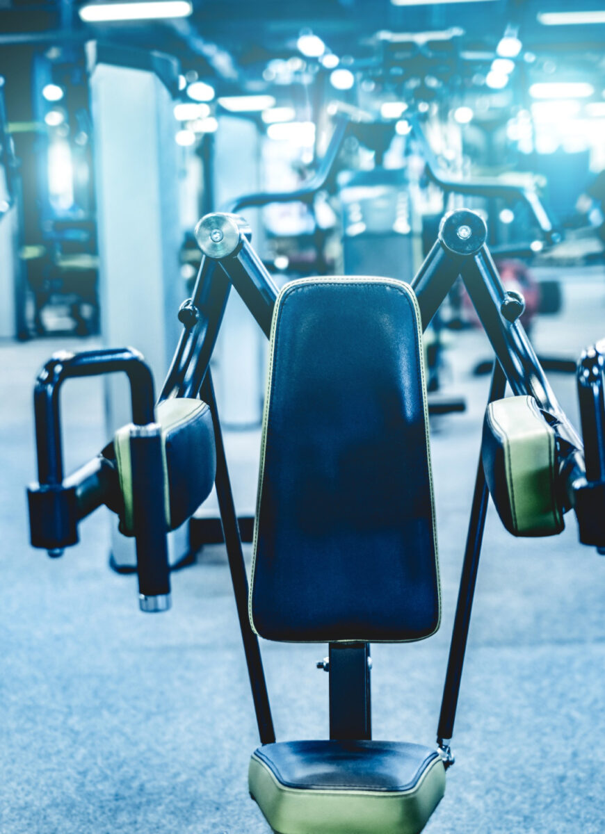 fitness bodybuilder machine shoulders at the gym
