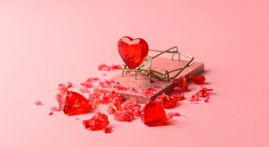 glass heart mousetrap pink background creative concept valentines day