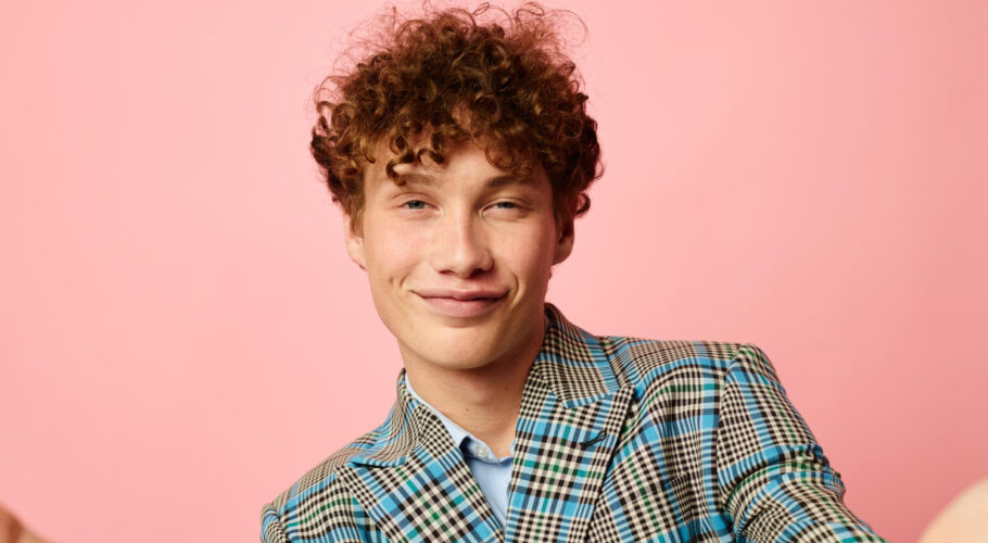 male with red curly hair business look in suit smiling happy emotions