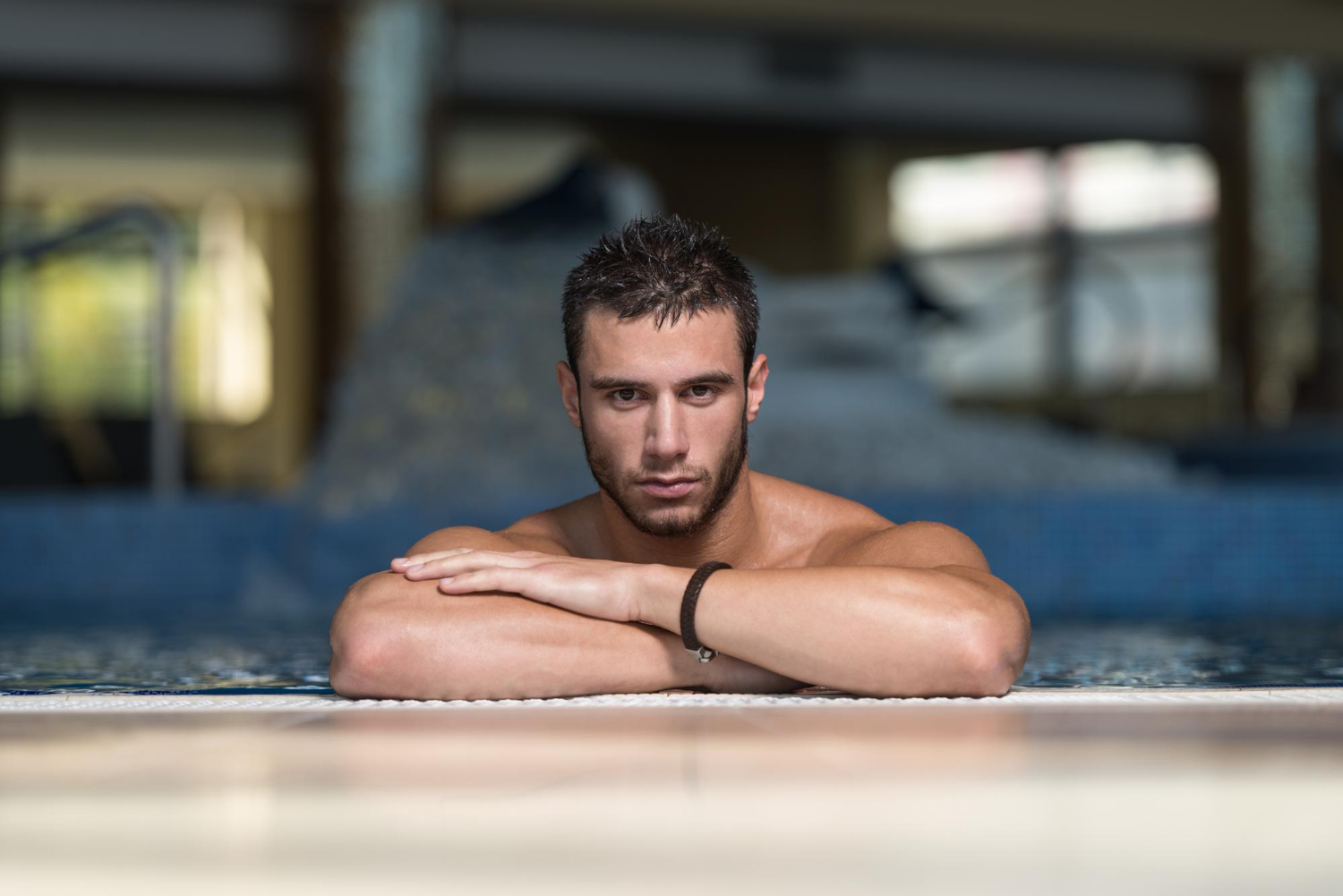 happy attractive man resting relaxed edge swimming pool