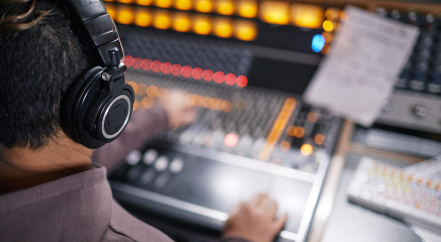 high angle view music producer wearing headphones audio workstation professional recording