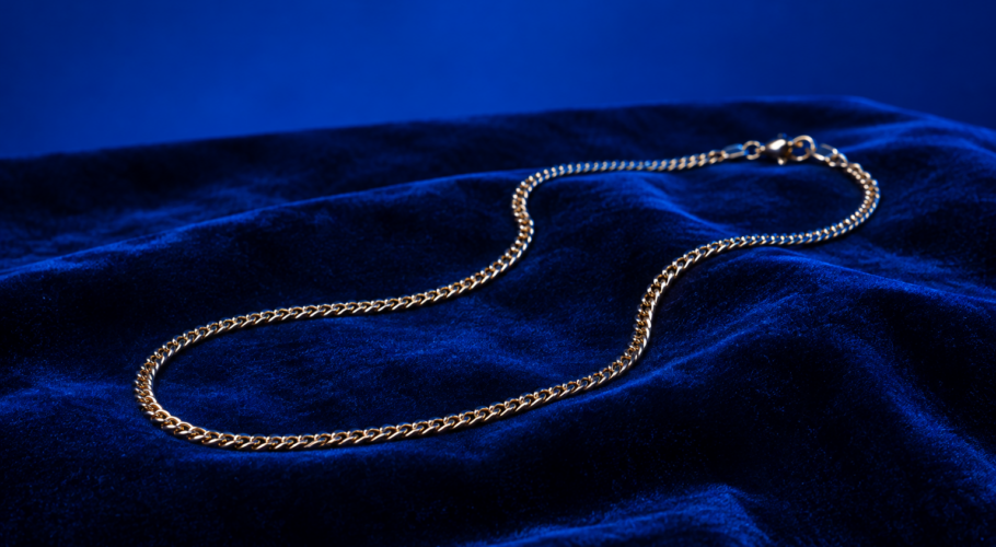Gold chain necklace on dark blue velvet