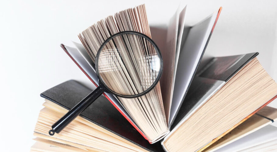 magnifying glass open paper book with pages concept academic research search studying