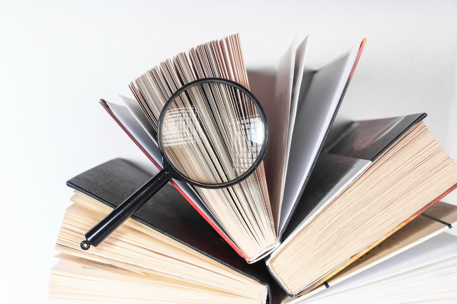 magnifying glass open paper book with pages concept academic research search studying