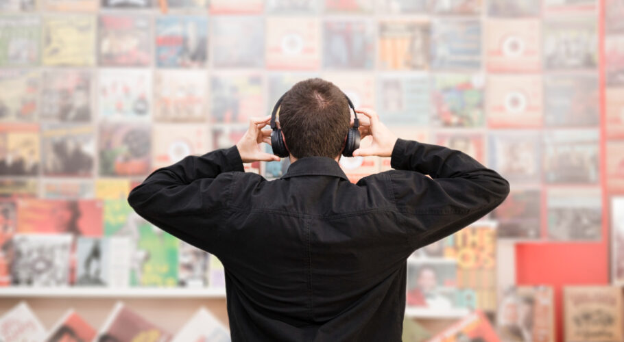 young man listening to music in CD store