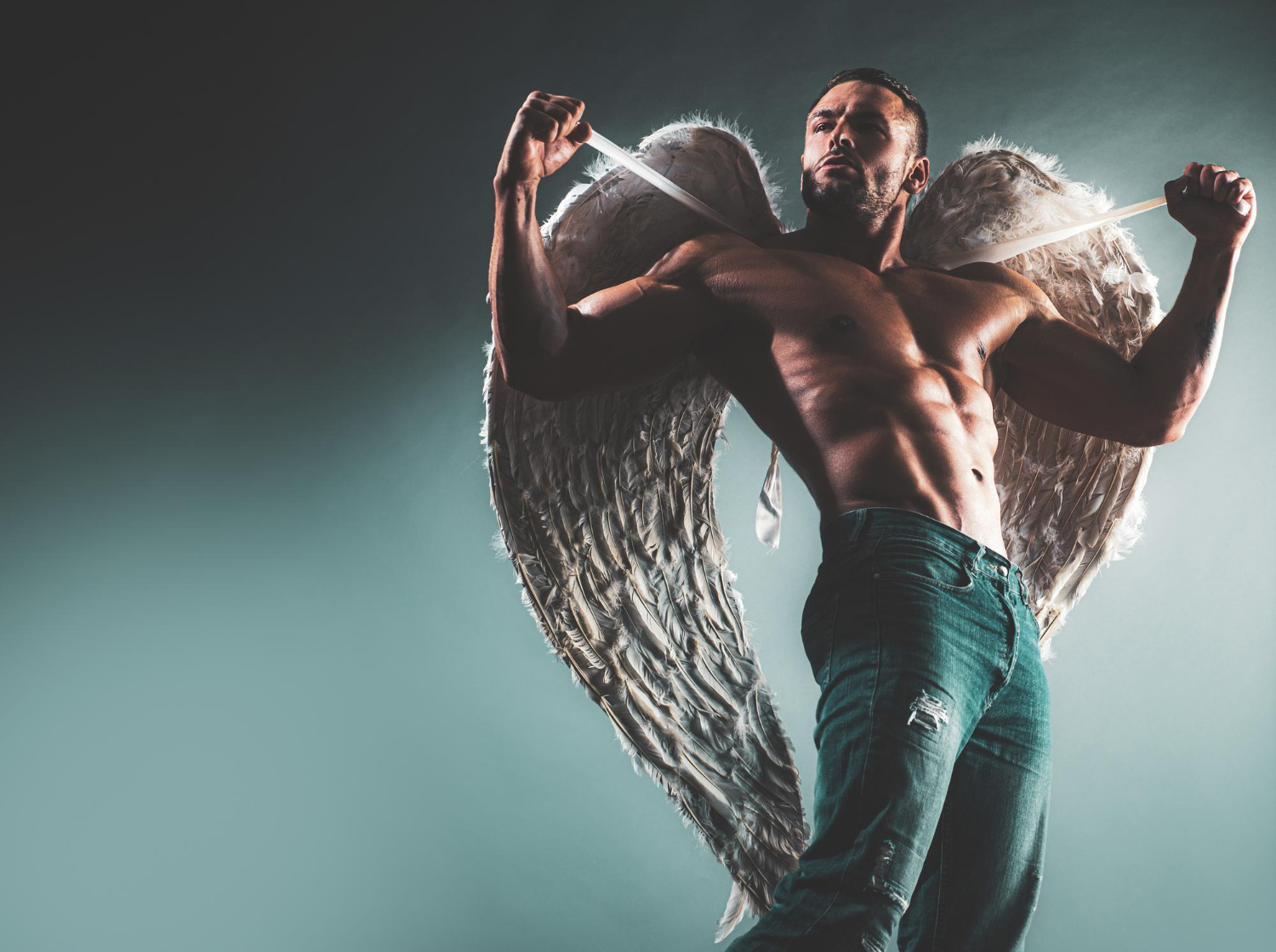 muscular sexy man with angels wings naked torso