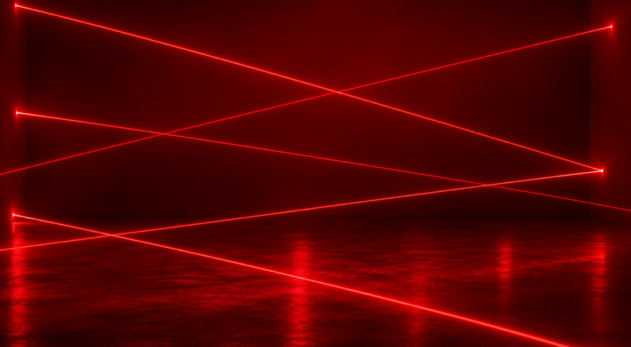 Red laser beams crossing a dark room