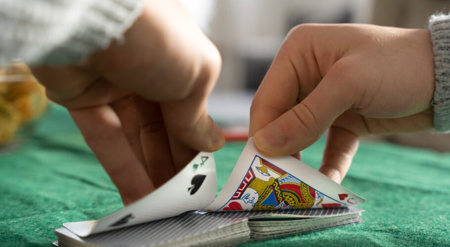 person having fun while playing poker with friends