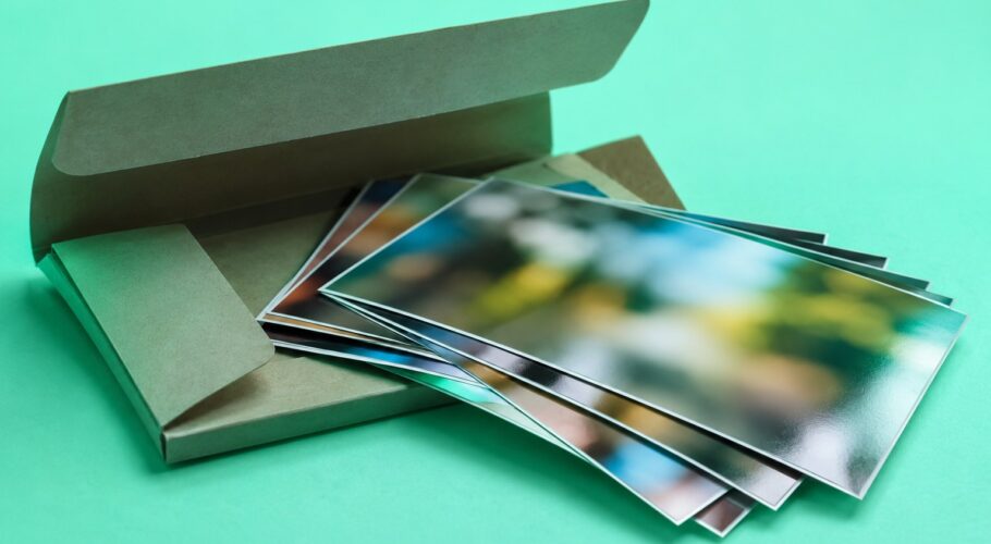 A photo lab wallet with fanned glossy prints
