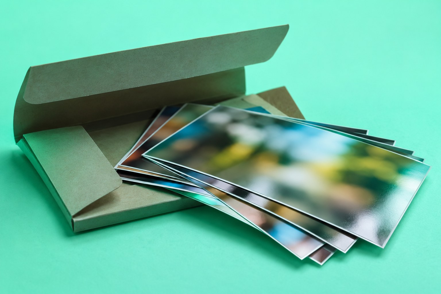 A photo lab wallet with fanned glossy prints