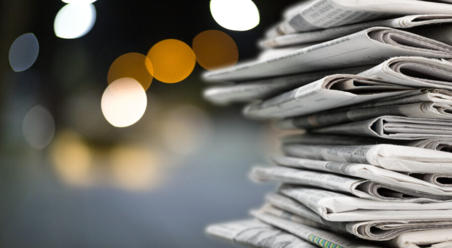 pile of stolen newspapers on nighttime background