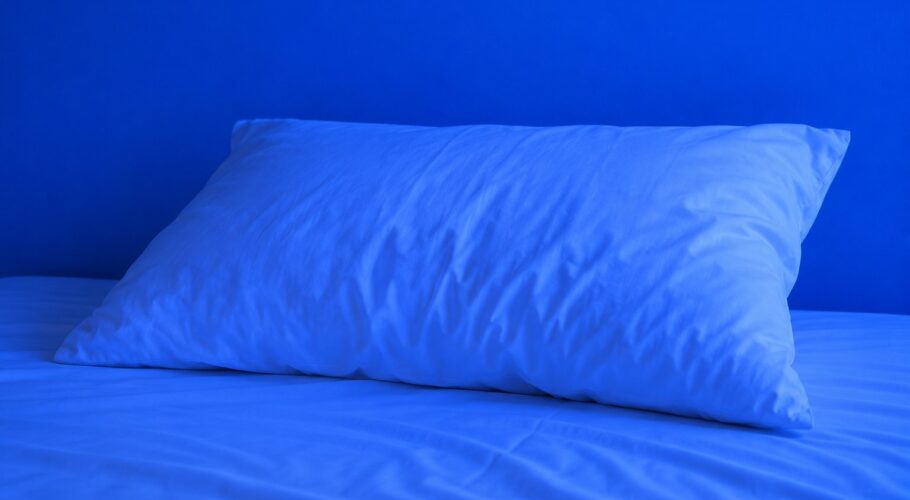 Single white pillow in blue light