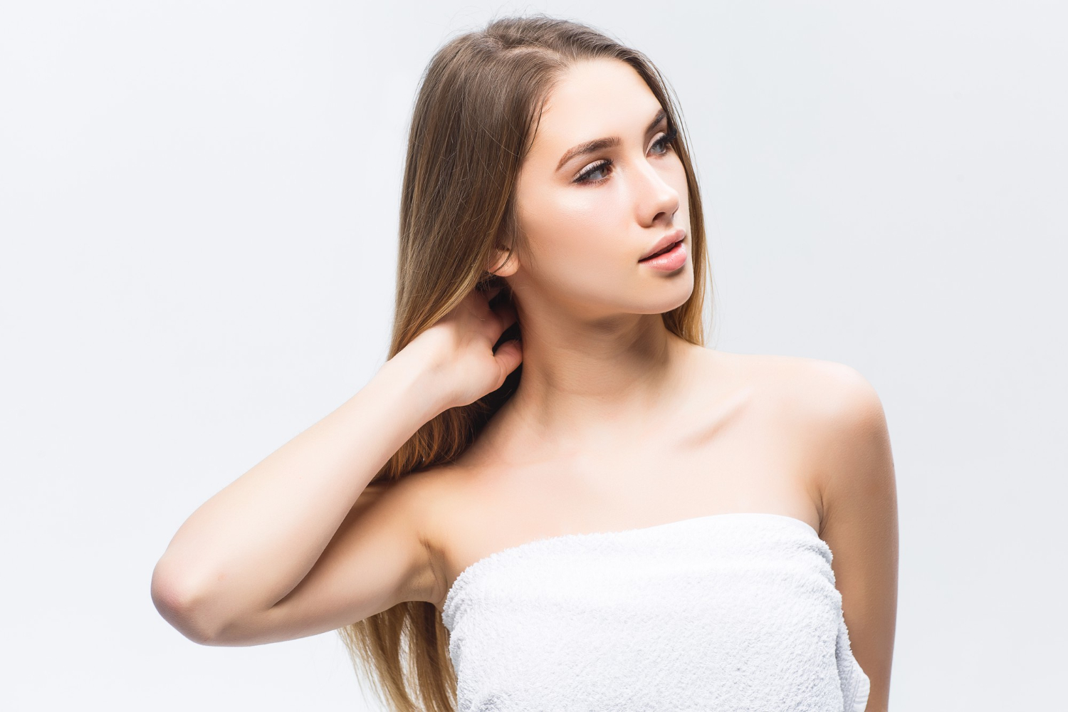 portrait attractive young woman madlyn touching smooth healthy skin her face looking away against white wall