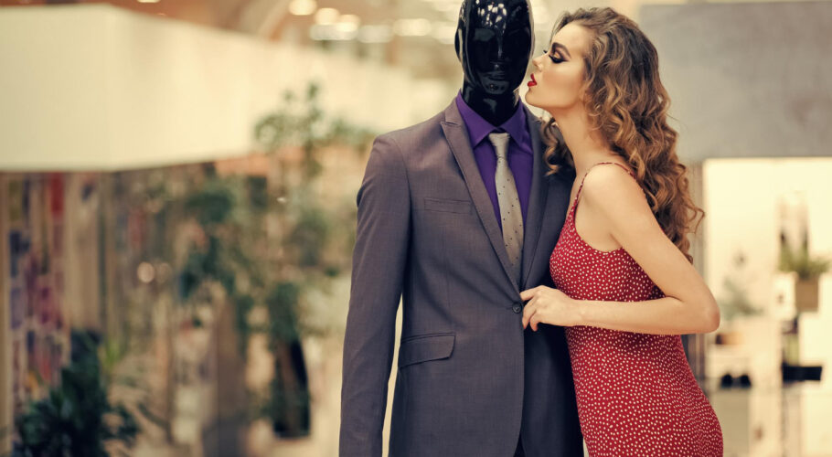 sensual woman with male mannequin clothing shopping