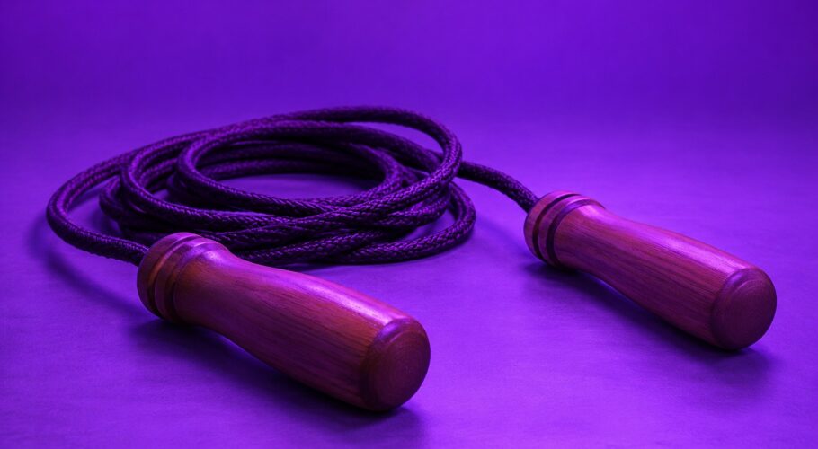A coiled skipping rope with wooden handles