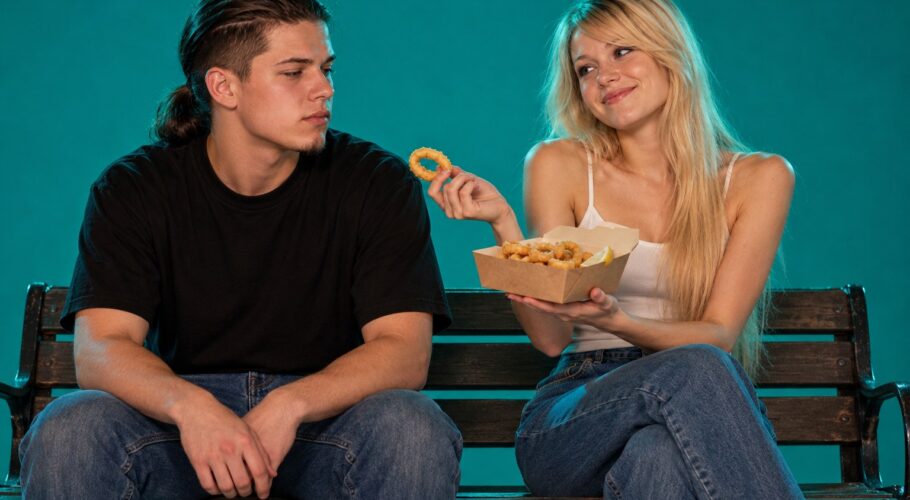 Tony and Lyssa sharing calamari rings on a park bench, April 1999