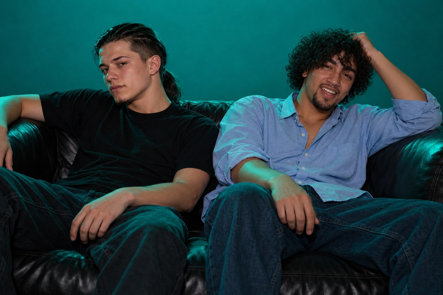 Ralf and Tony slumped, worn out, on a dark nightclub sofa