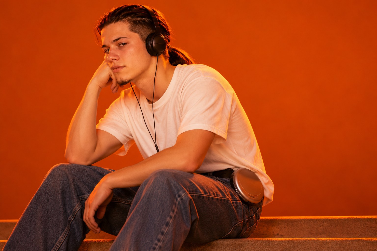 Tony sitting bored on a front step wearing headphones with a discman
