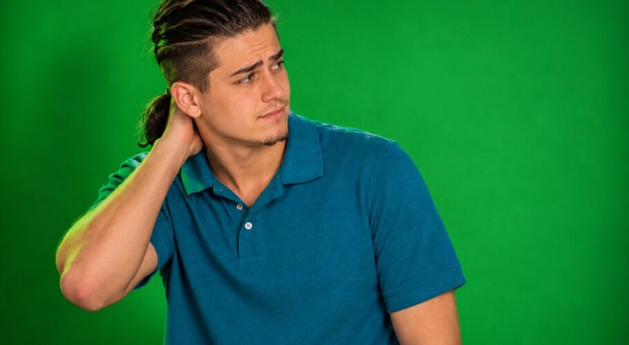 Tony in a teal polo with a hand behind his head looking worried, September 1998