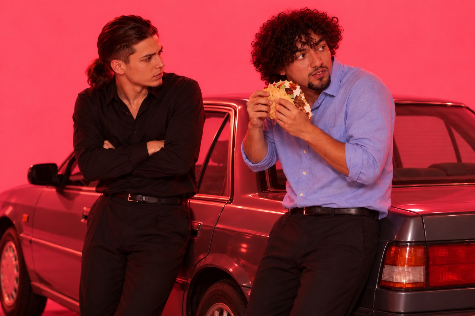 Tony leaning on a sedan with arms crossed while Ralf eats a taco, March 1999