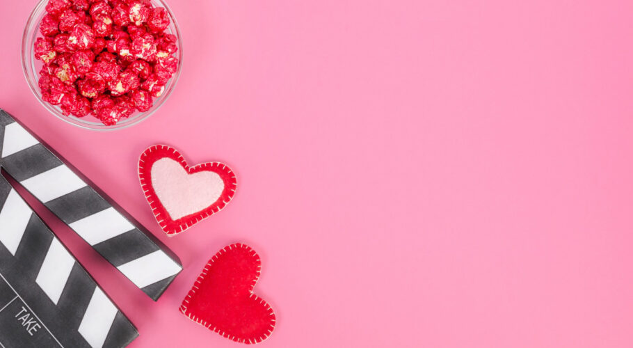 valentines day movie concept movie clapperboard with hearts red caramel popcorn with