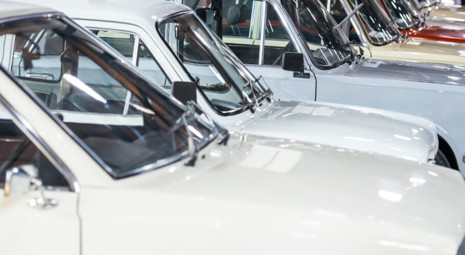 white cars in used car yard being sold in parking lot