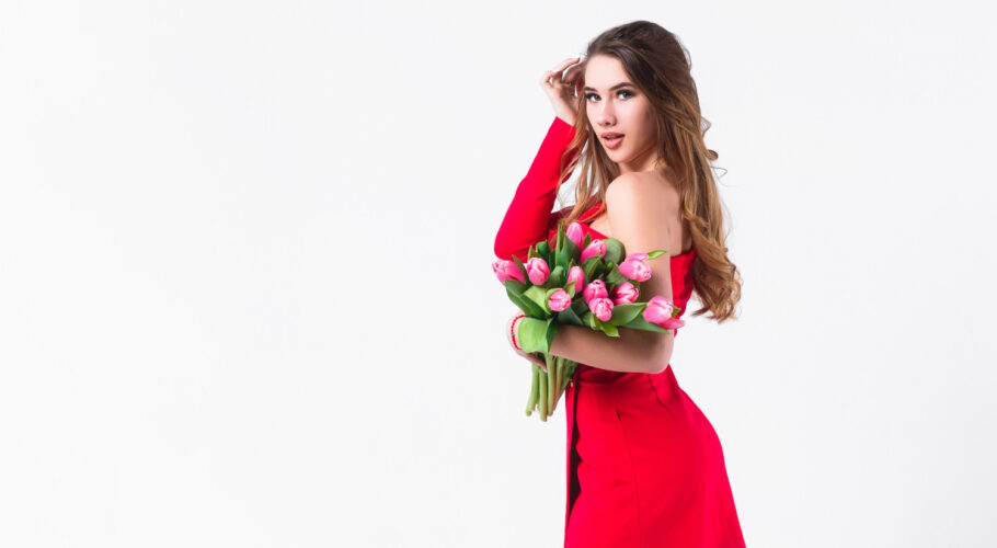 young attractive girl holding beautiful pink tulips white wall madlyn.