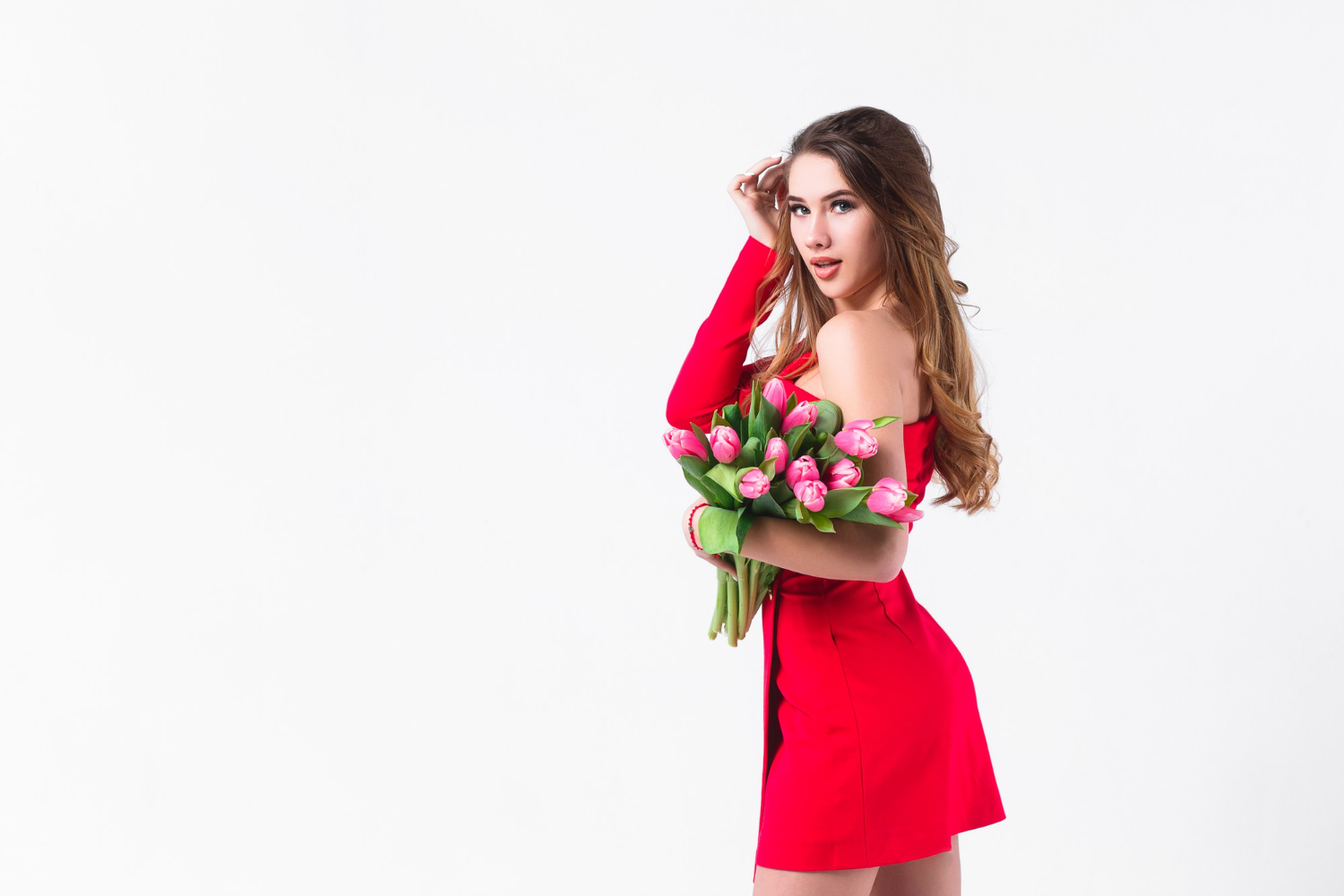 young attractive girl holding beautiful pink tulips white wall madlyn.