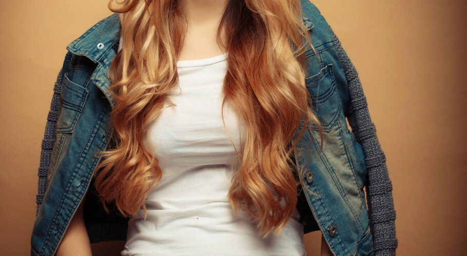young beautiful curly woman tarina posing with hands on pockets