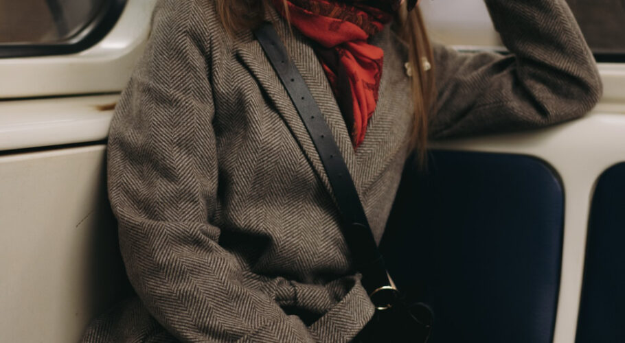 Young Brunette Lady In Coat On Train Looking Out Window