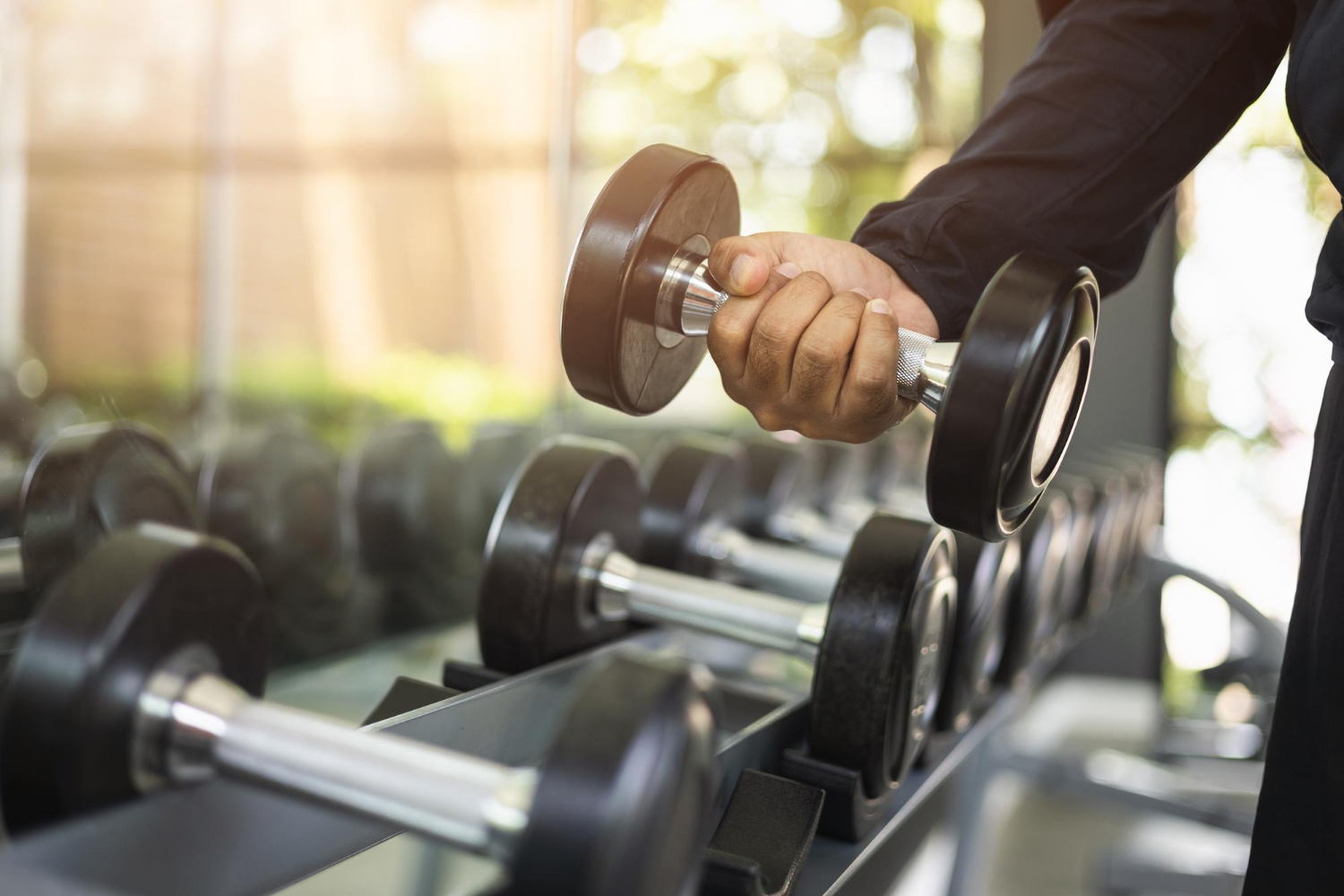 young fitness man with dumbbell gym weight training exercise gym lifting dumbbell bodybuilder good health