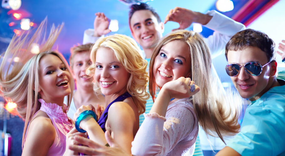 young friends dancing drinking smoking at a house party